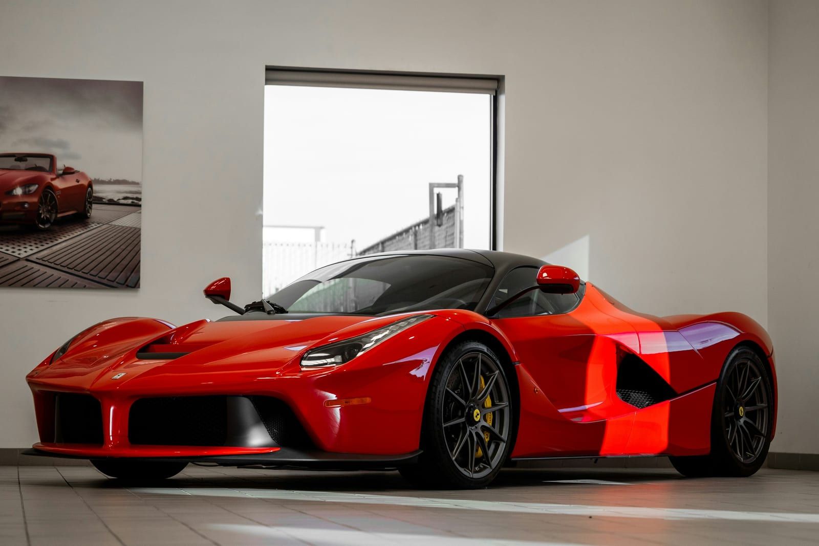 Red supercar with flawless gloss paint in a showroom