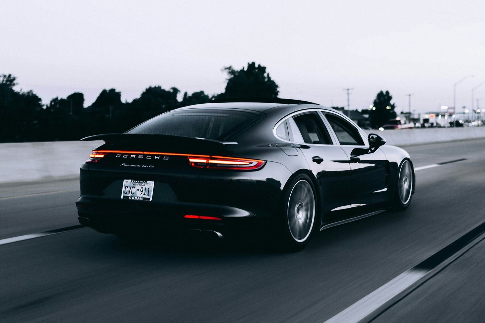 Black saloon with dark tinted side and rear windows on a highway